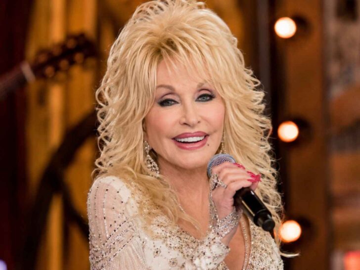 Dolly Parton smiling with a microphone