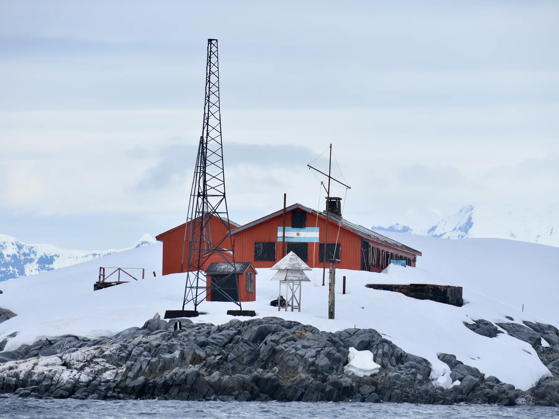 Red research station on the snowy Antarctic coast