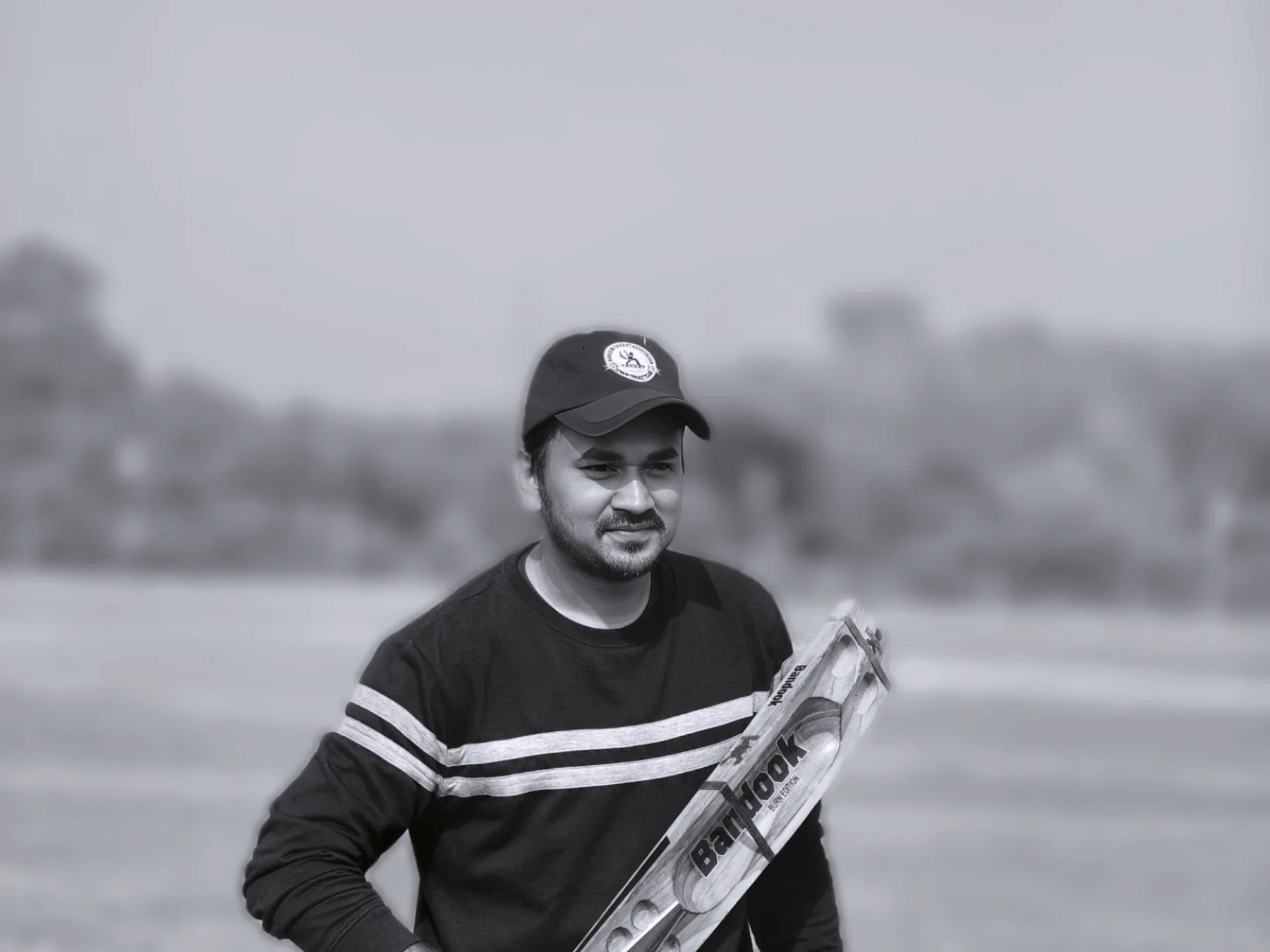 Cricketer holding a bat on the field