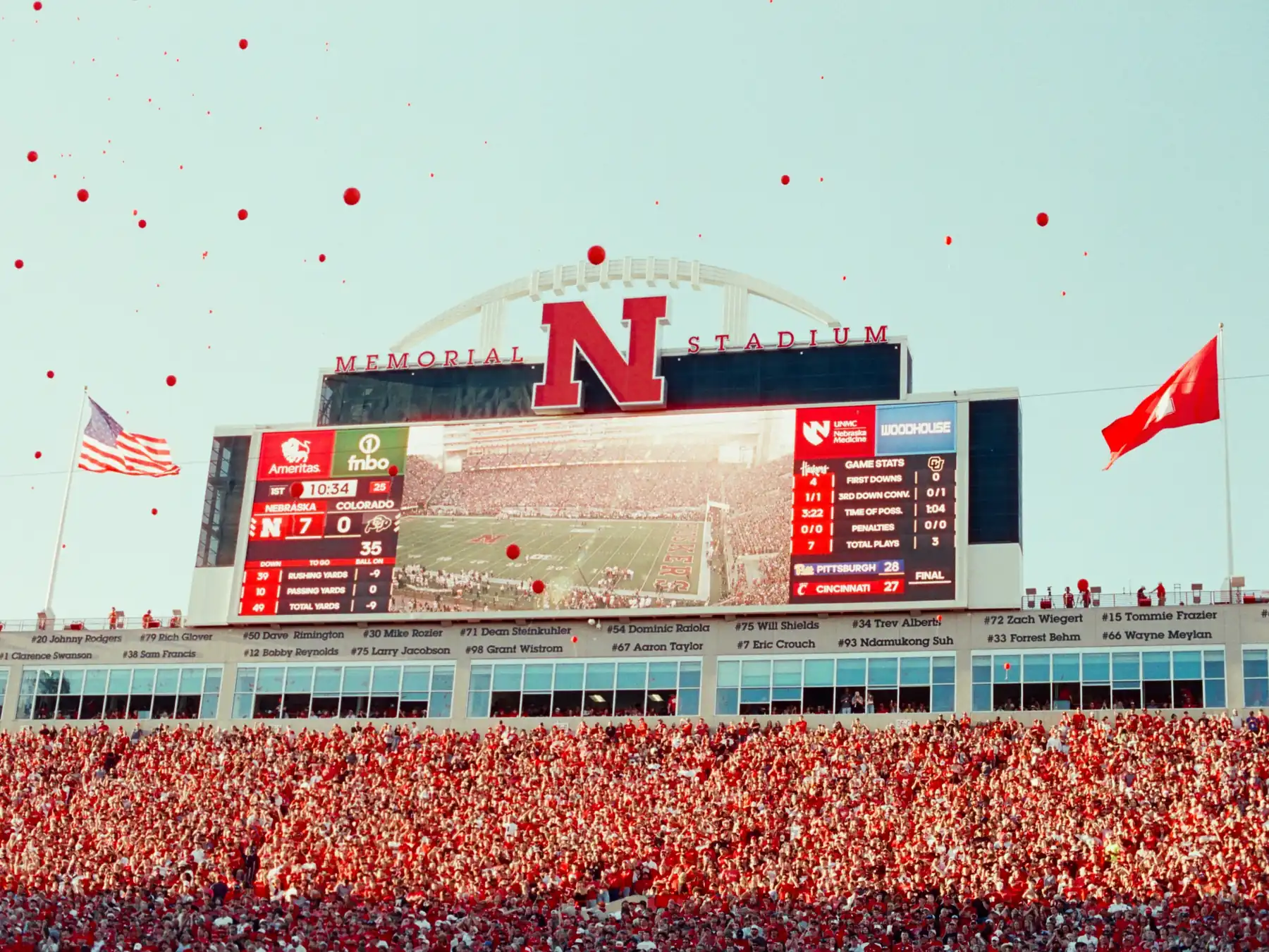 Football fans and stadium scoreboard