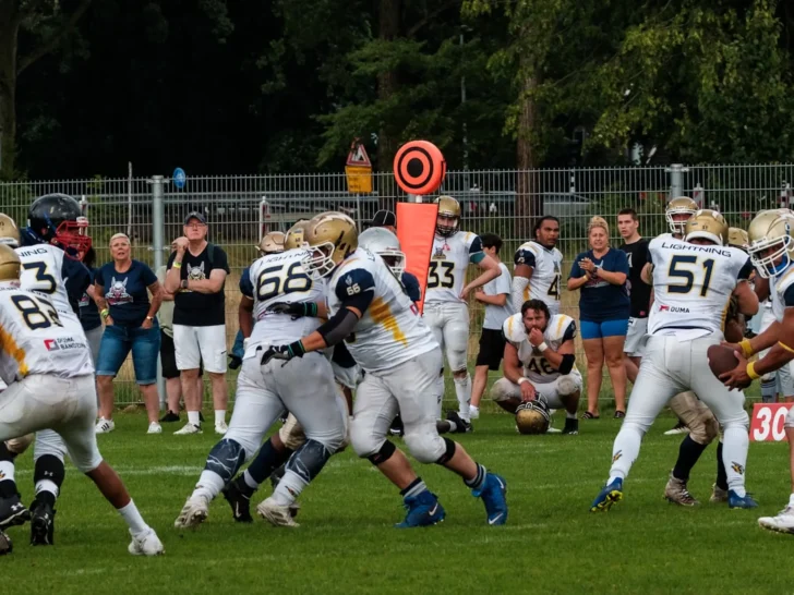 American football players battling at the line of scrimmage during a game