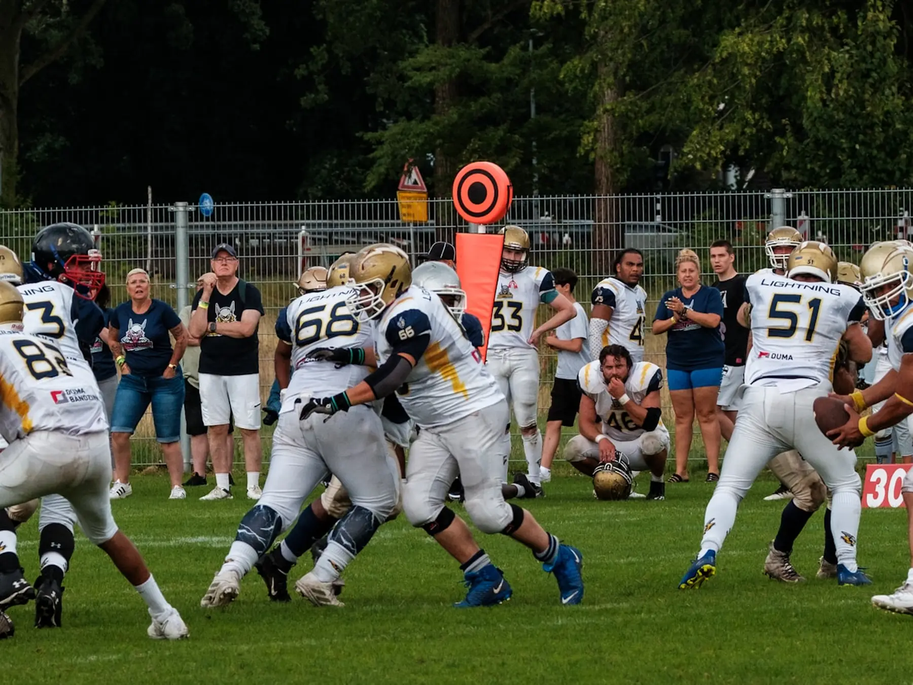 American football players battling at the line of scrimmage during a game