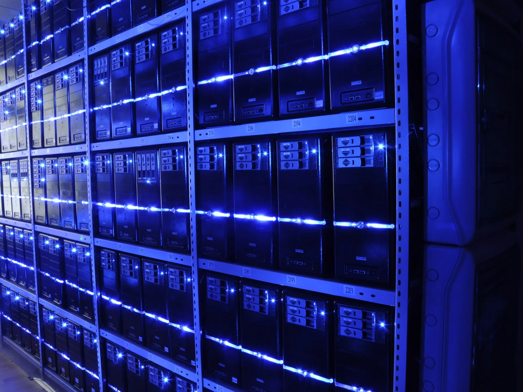 Rows of illuminated servers in a data center