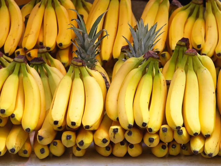 Display of ripe yellow banana bunches at a produce market