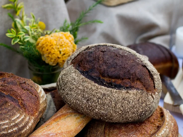 Round artisan bread loaves with scored crusts on a table
