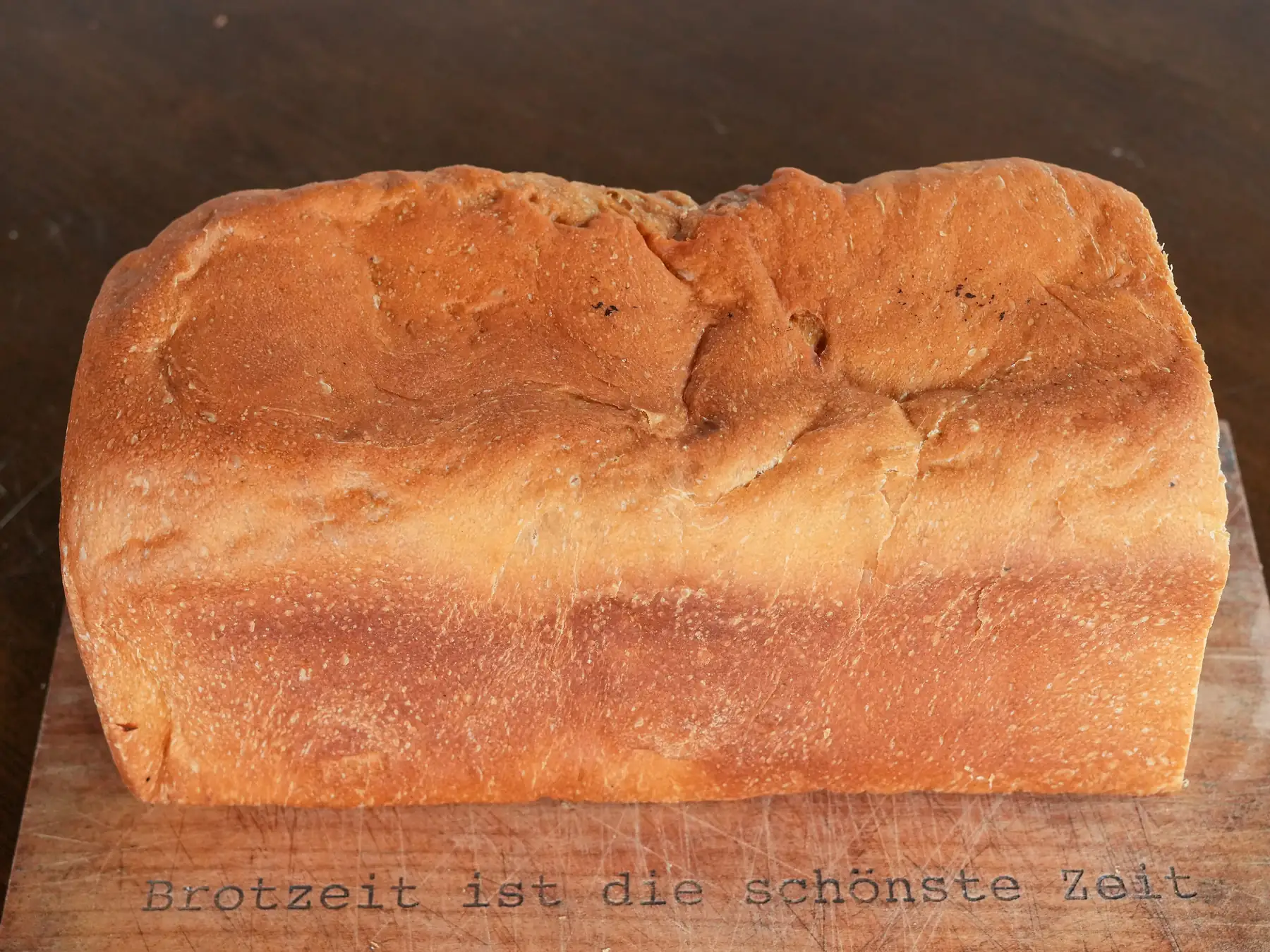 Freshly baked rectangular bread loaf with a golden crust