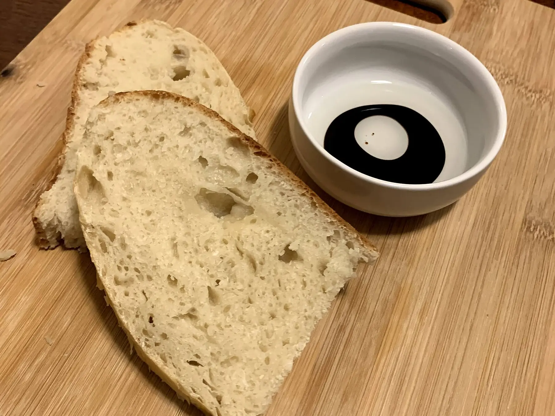 Slices cut from a loaf of herb bread on a plate