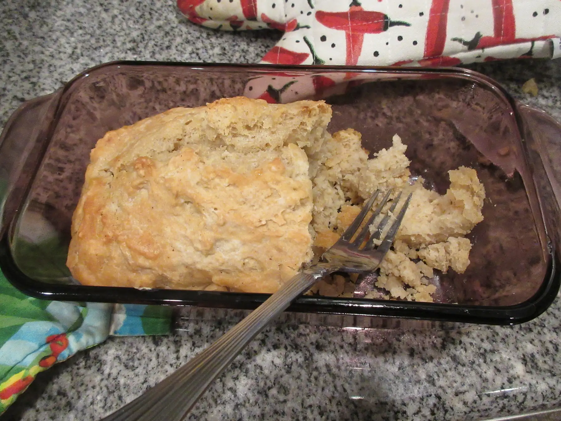Homemade bread resting in a rectangular baking pan