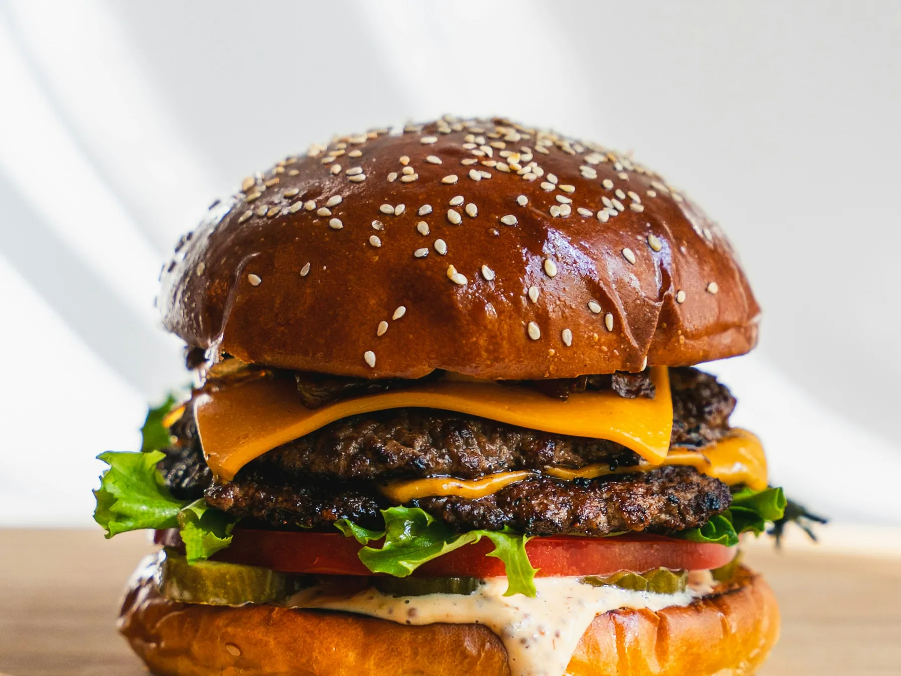 Tall cheeseburger with fresh toppings