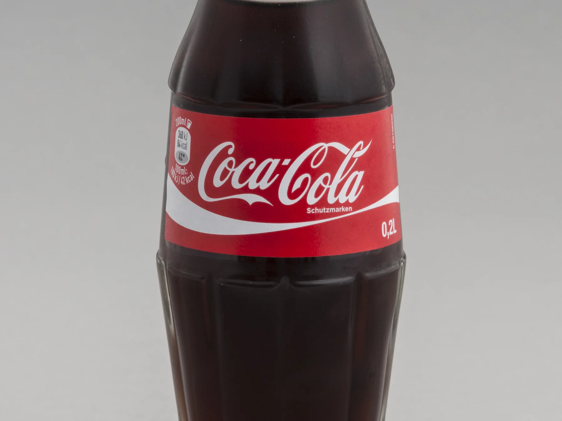 Classic chilled Coca-Cola glass bottle with a red label