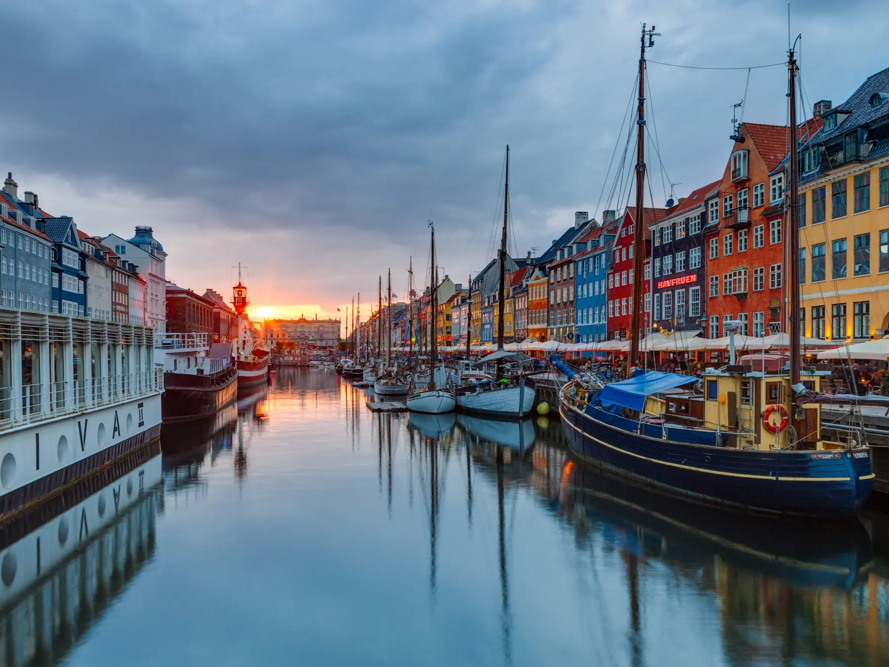 Colorful buildings and boats lining Nyhavn harbor in Copenhagen, Denmark