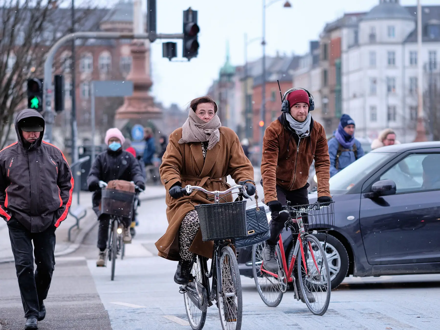 People riding bicycles through Copenhagen on a winter day