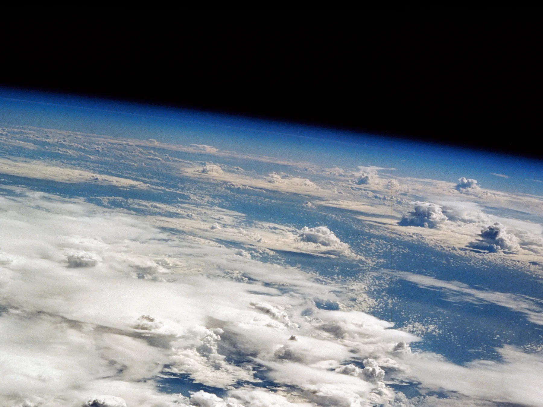 Earth's curved horizon and blue atmosphere viewed from orbit
