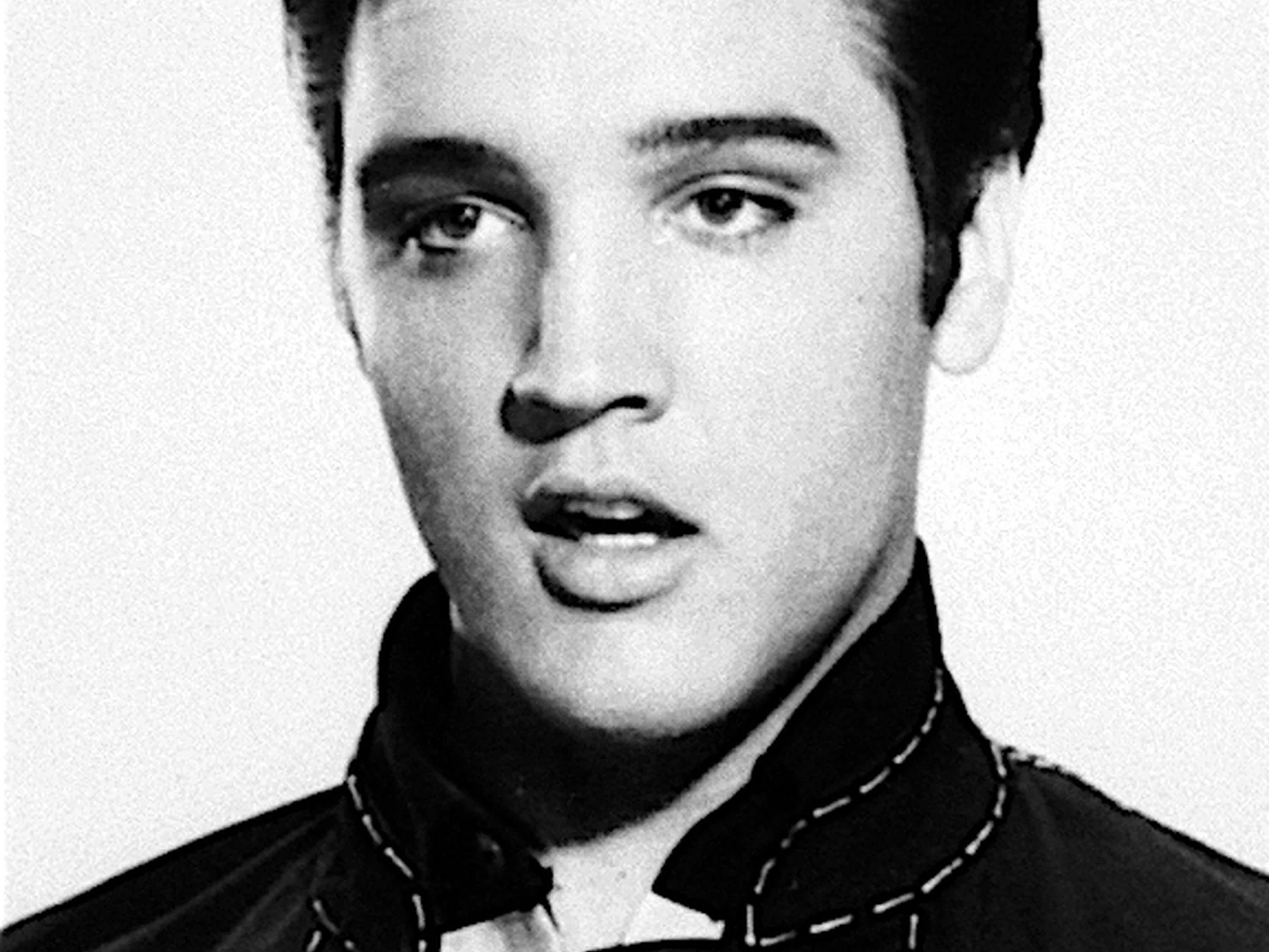 Young Elvis Presley in a black-and-white portrait