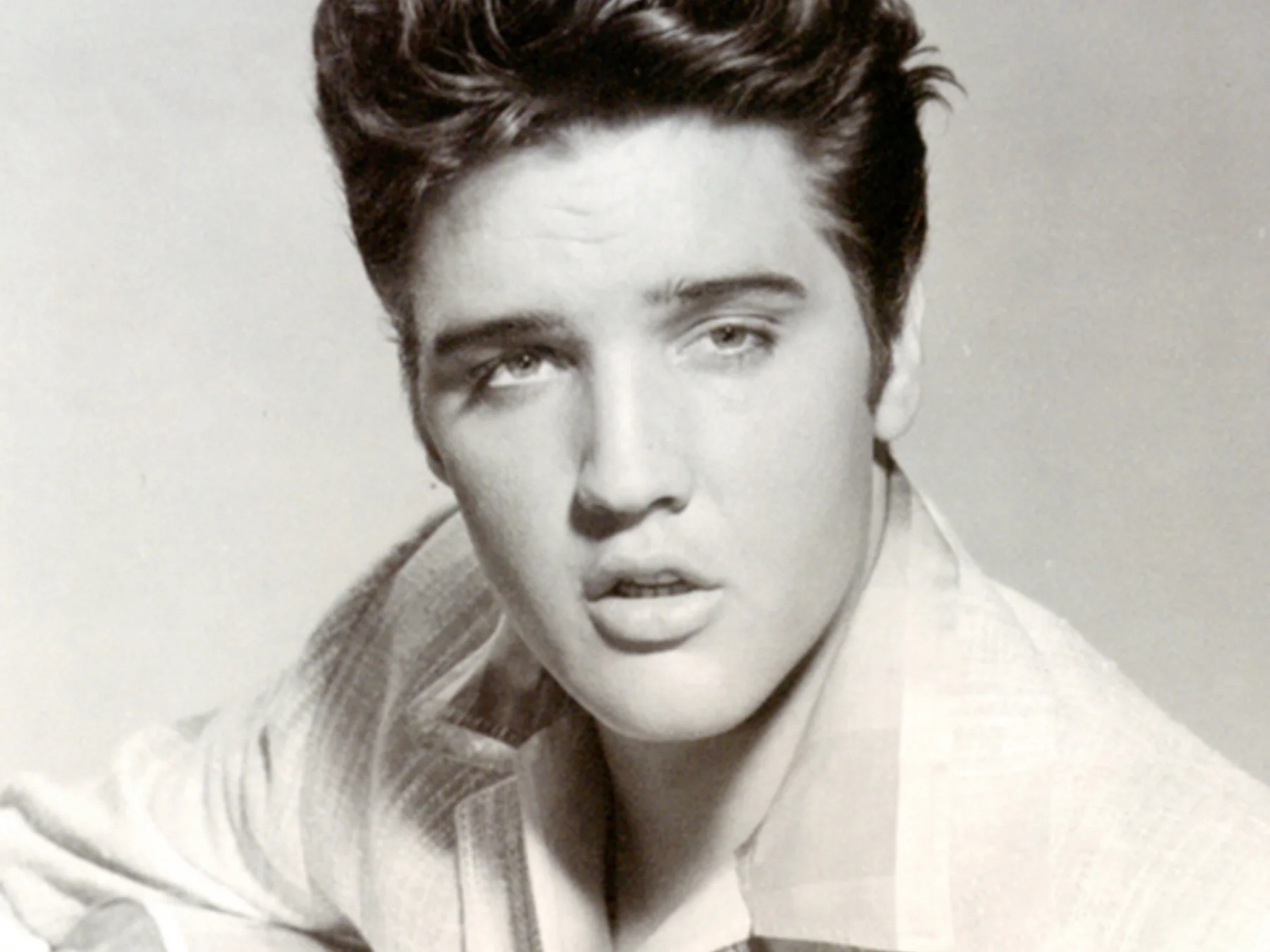 Elvis Presley posing for a studio photograph