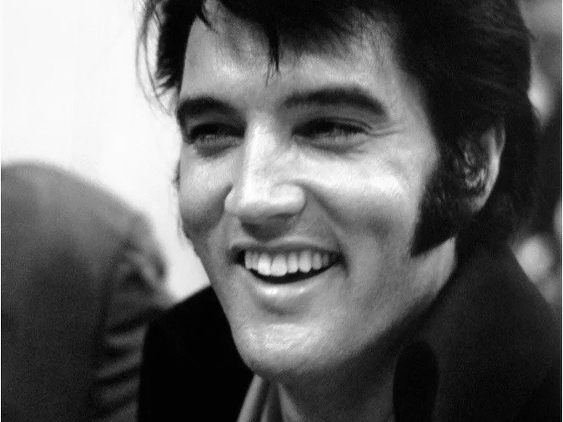 Elvis Presley smiling in a candid photograph
