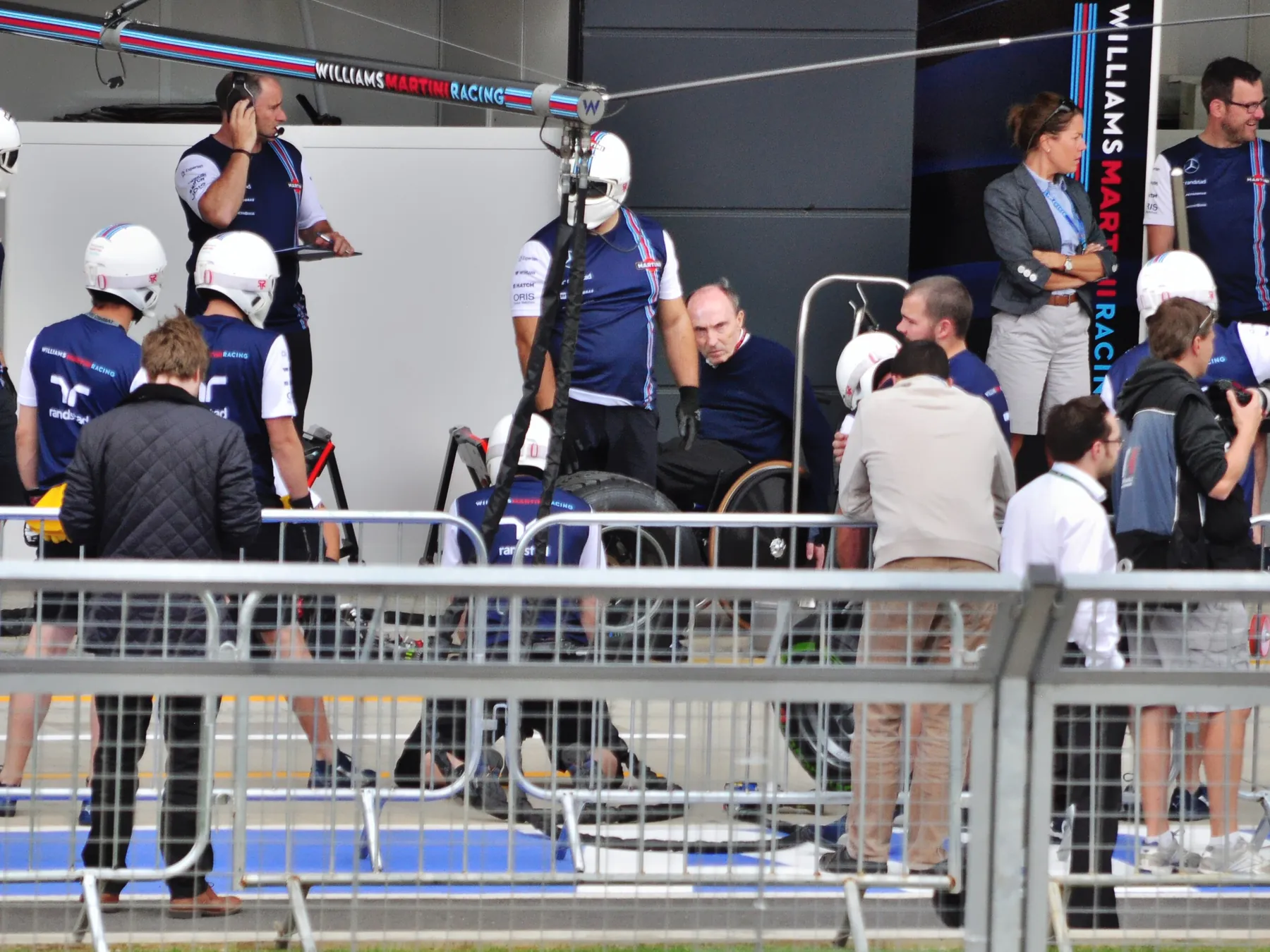 Formula One team members working in a pit garage