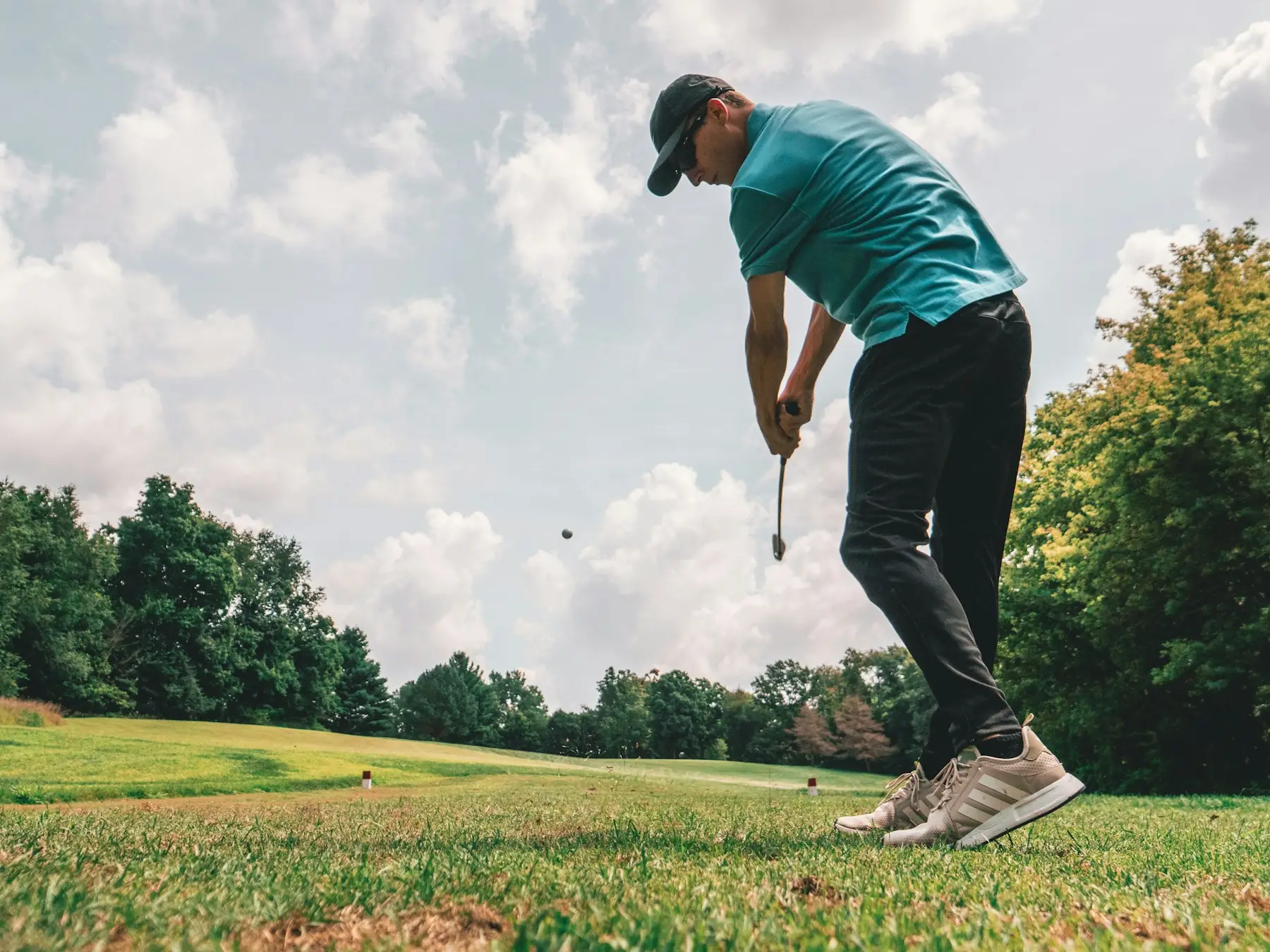 Golfer striking a ball from the fairway