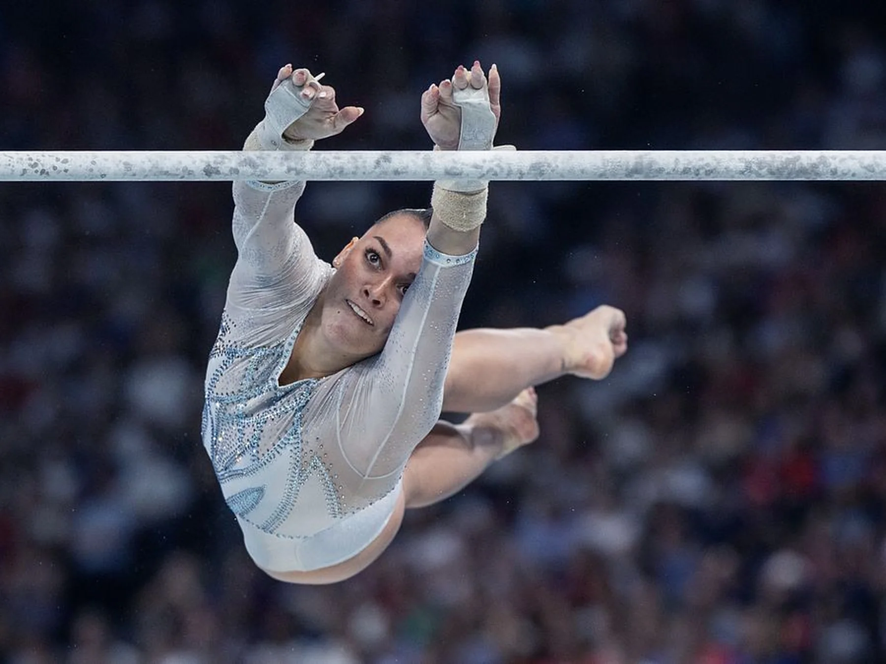 Artistic gymnast airborne during a competition