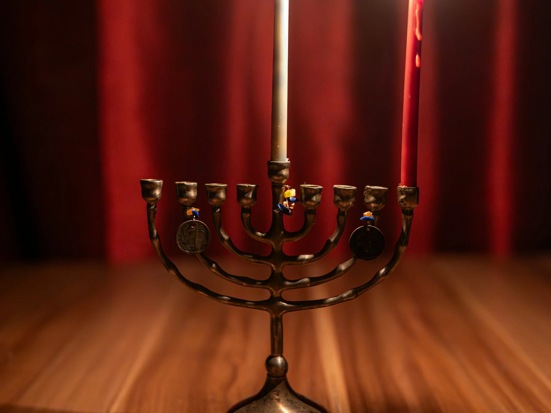 Hanukkah menorah with lit candles and a dreidel on a table