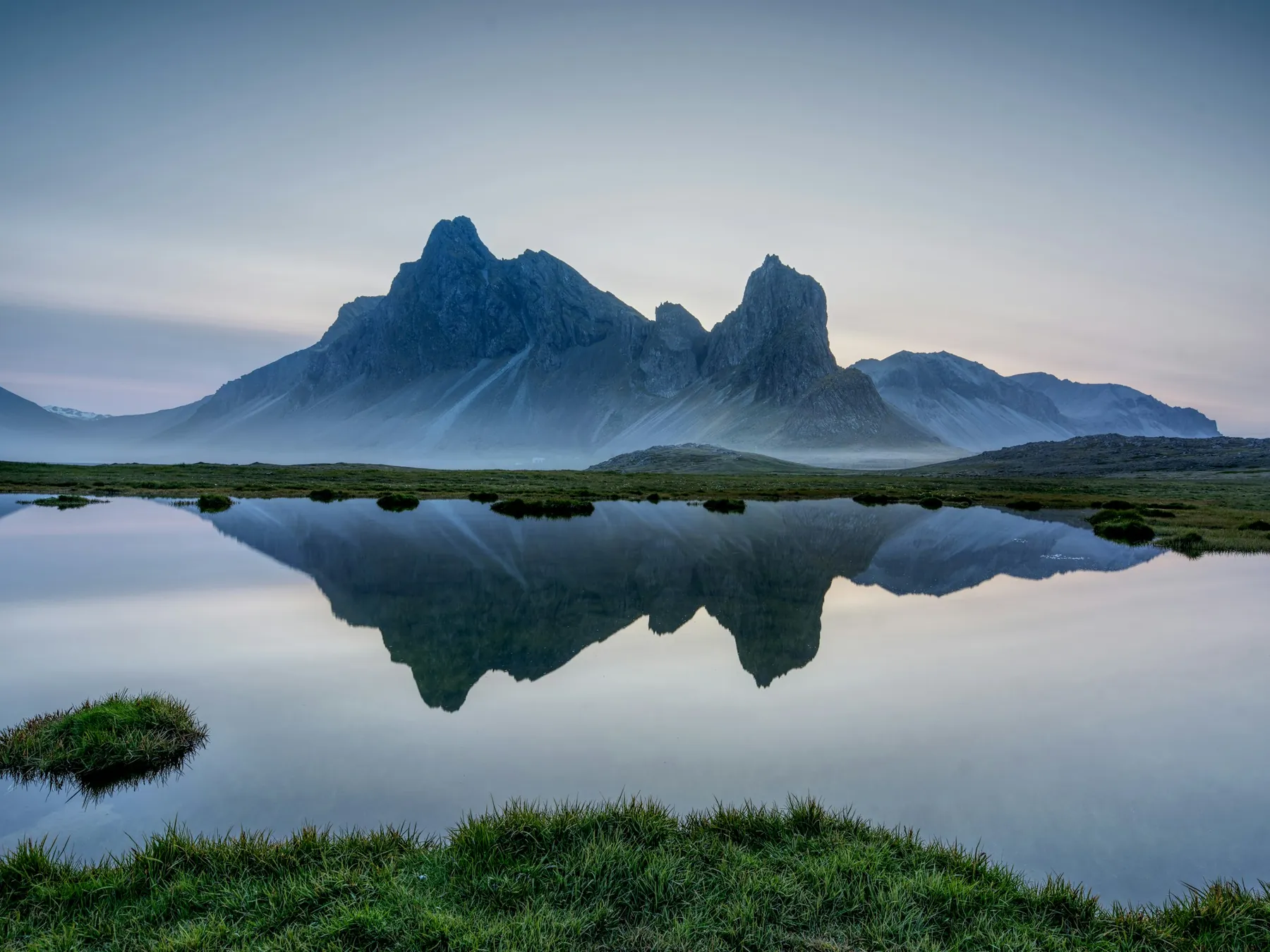 Icelandic mountains reflected in still water