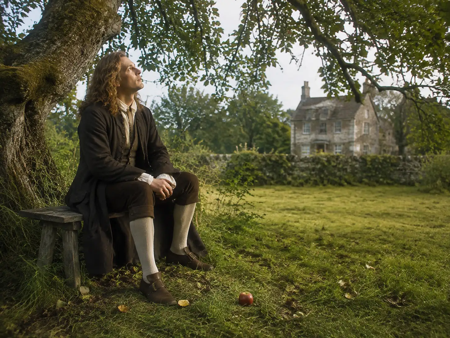 Isaac Newton seated beneath an apple tree at Woolsthorpe Manor