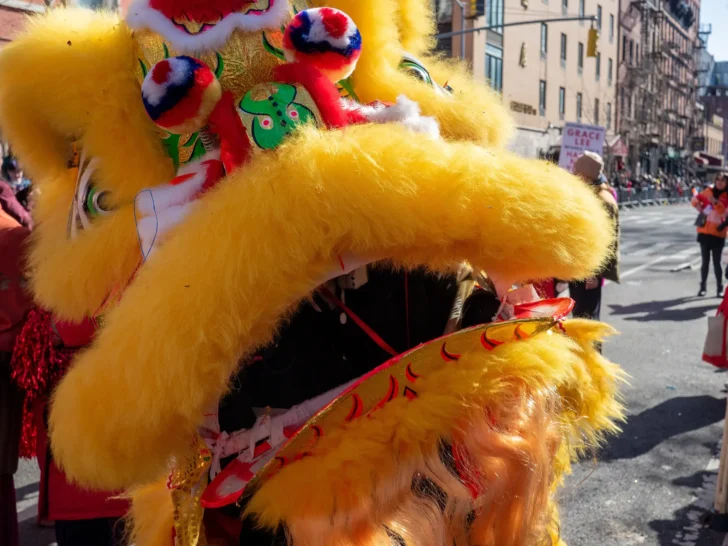 Bright yellow lion dance costume during a Lunar New Year street celebration