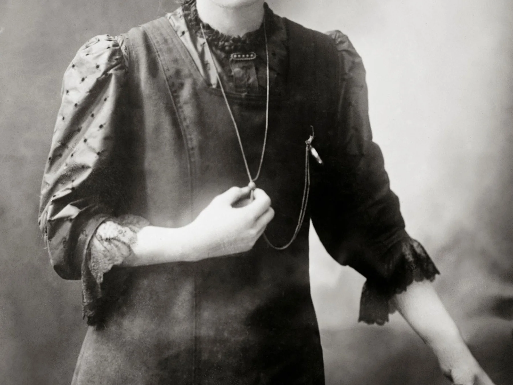 Marie Curie wearing a dark dress in a historic photograph