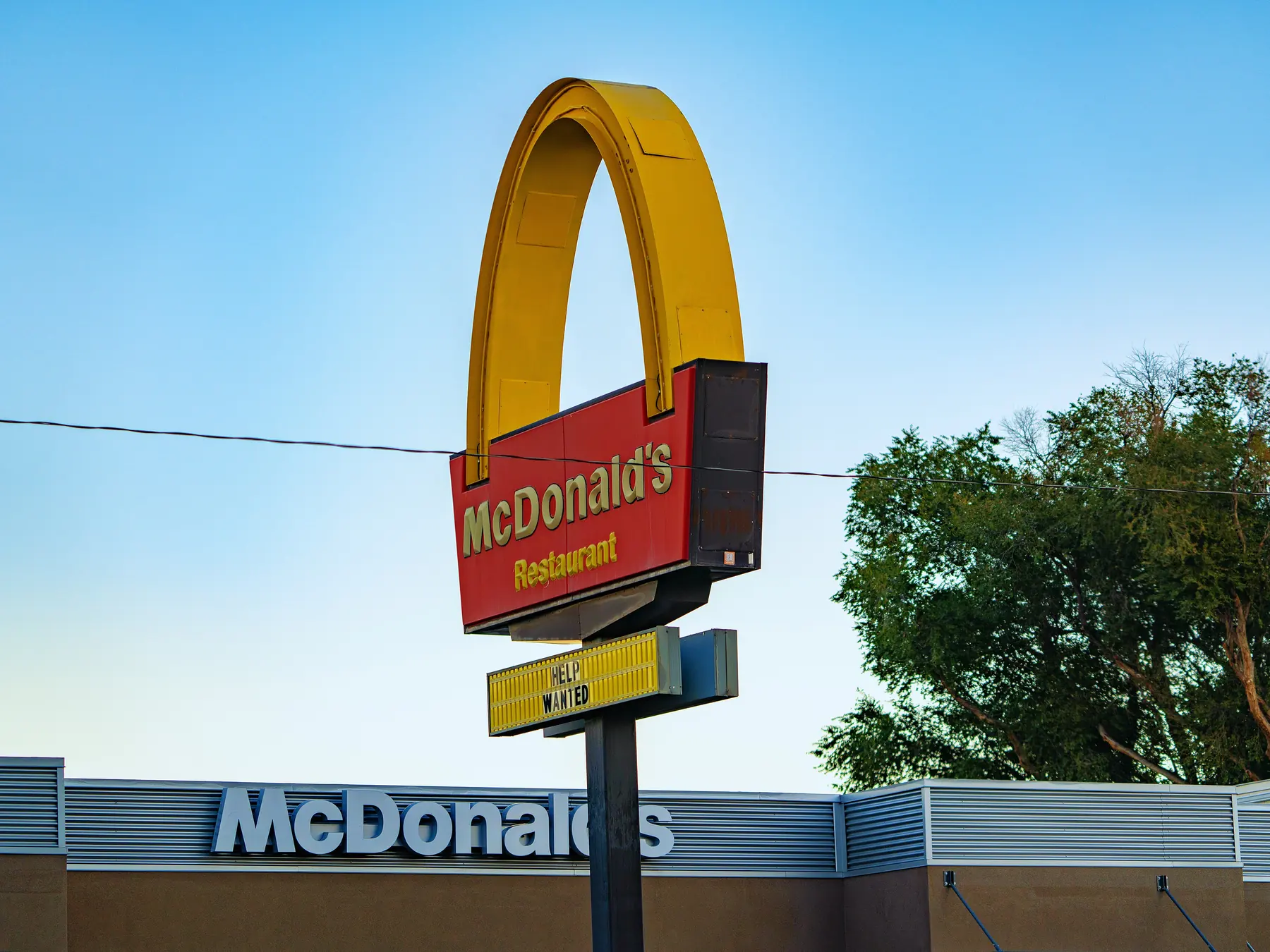 McDonald's restaurant with the Golden Arches sign against a blue sky