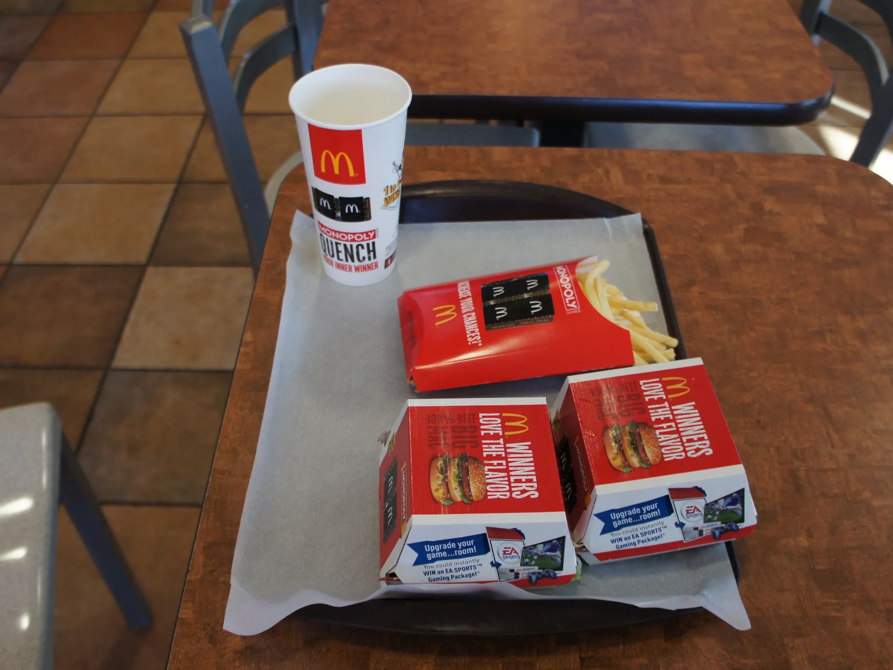 McDonald's meal with burger boxes, french fries, and a drink on a restaurant table