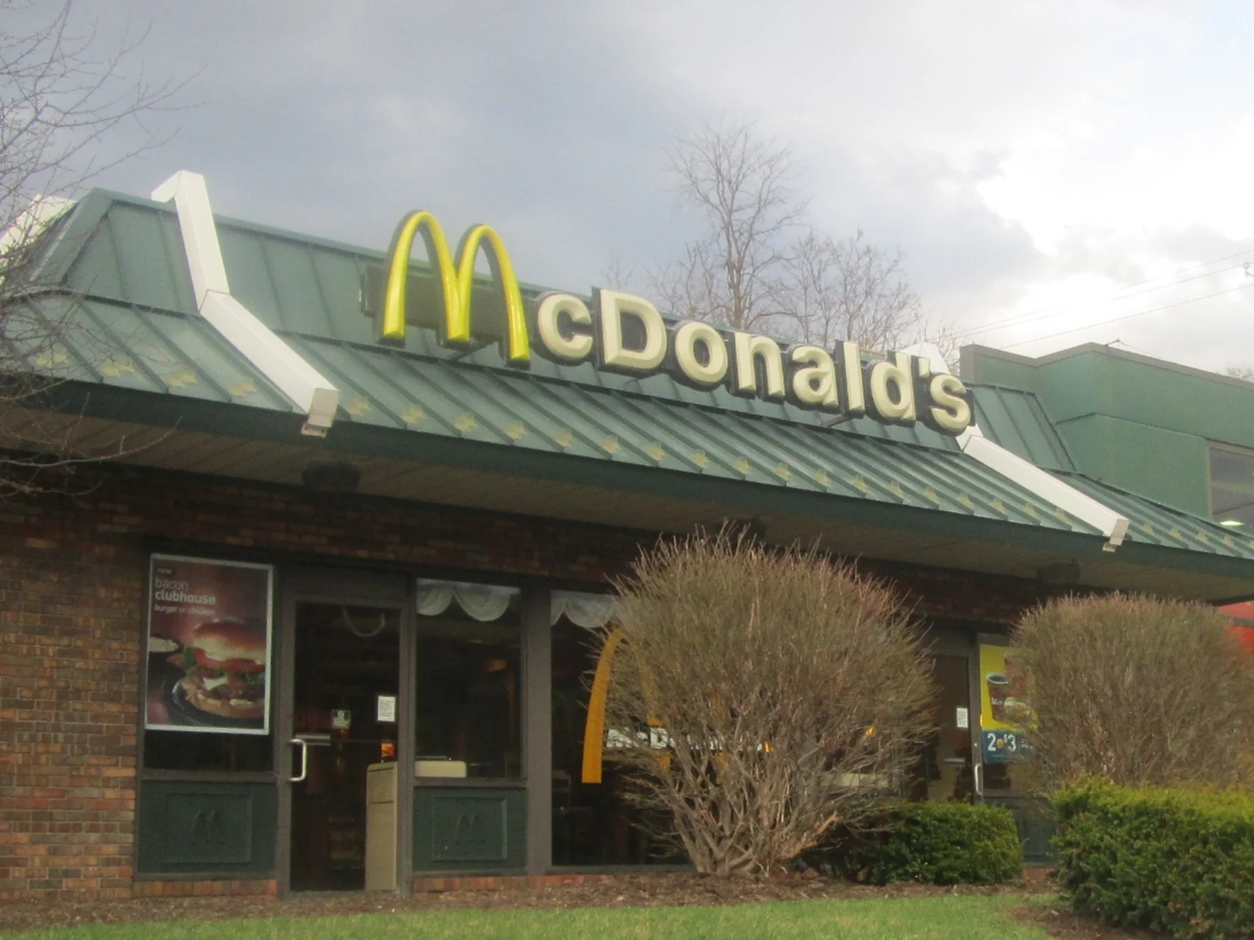 Exterior of a McDonald's restaurant with its name and Golden Arches