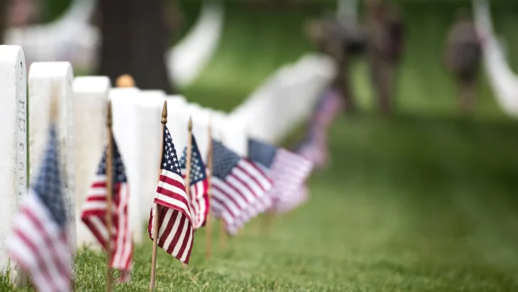 Small American flags beside military grave markers