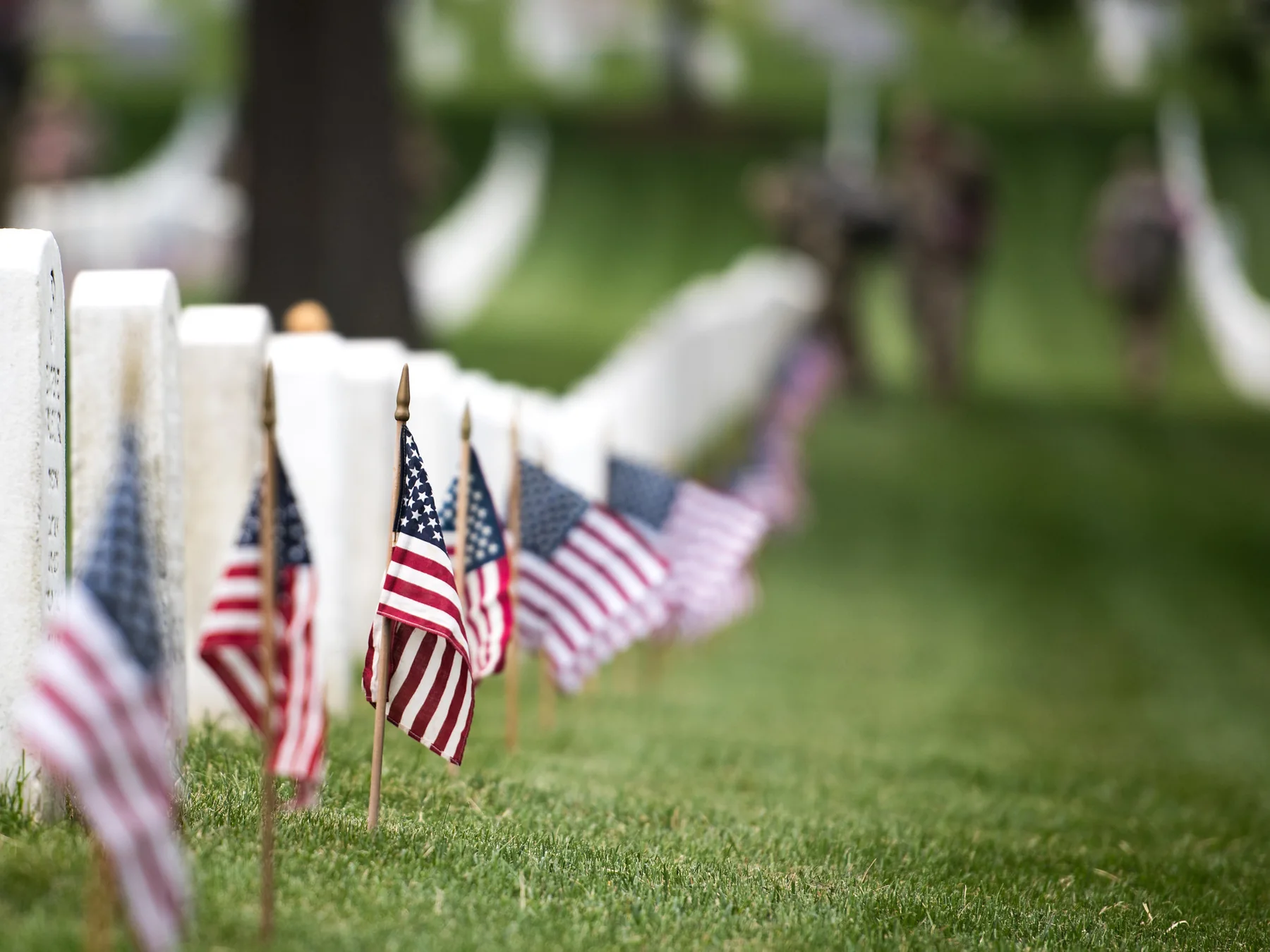 Small American flags placed beside grave markers