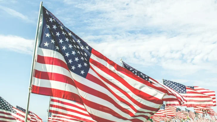 Rows of American flags at a veterans cemetery