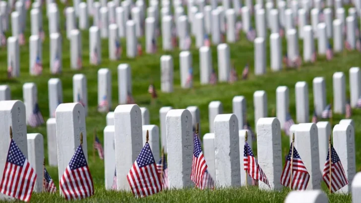 Gravestones decorated with American flags in remembrance of military service