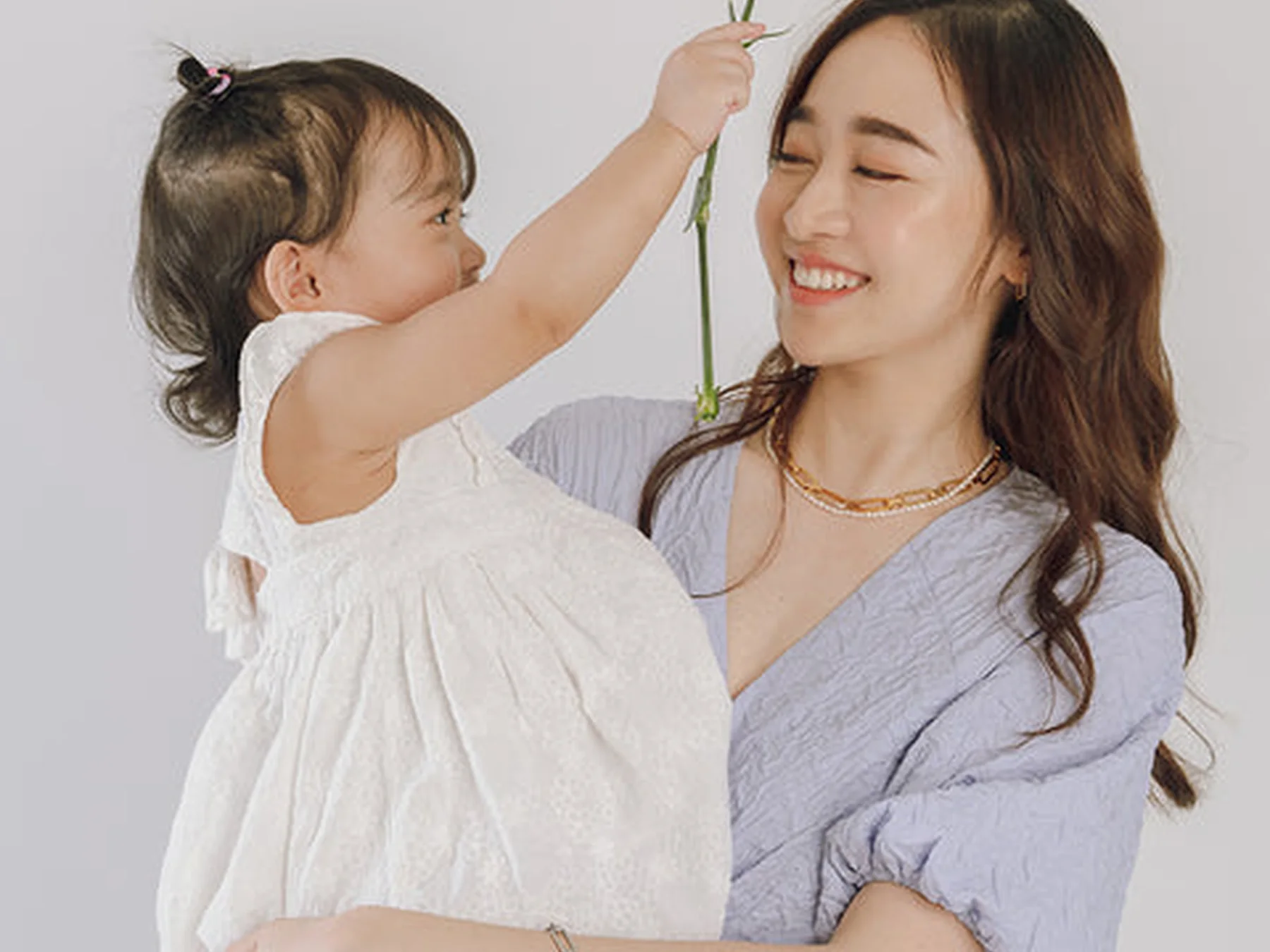 Young daughter giving her mother a flower