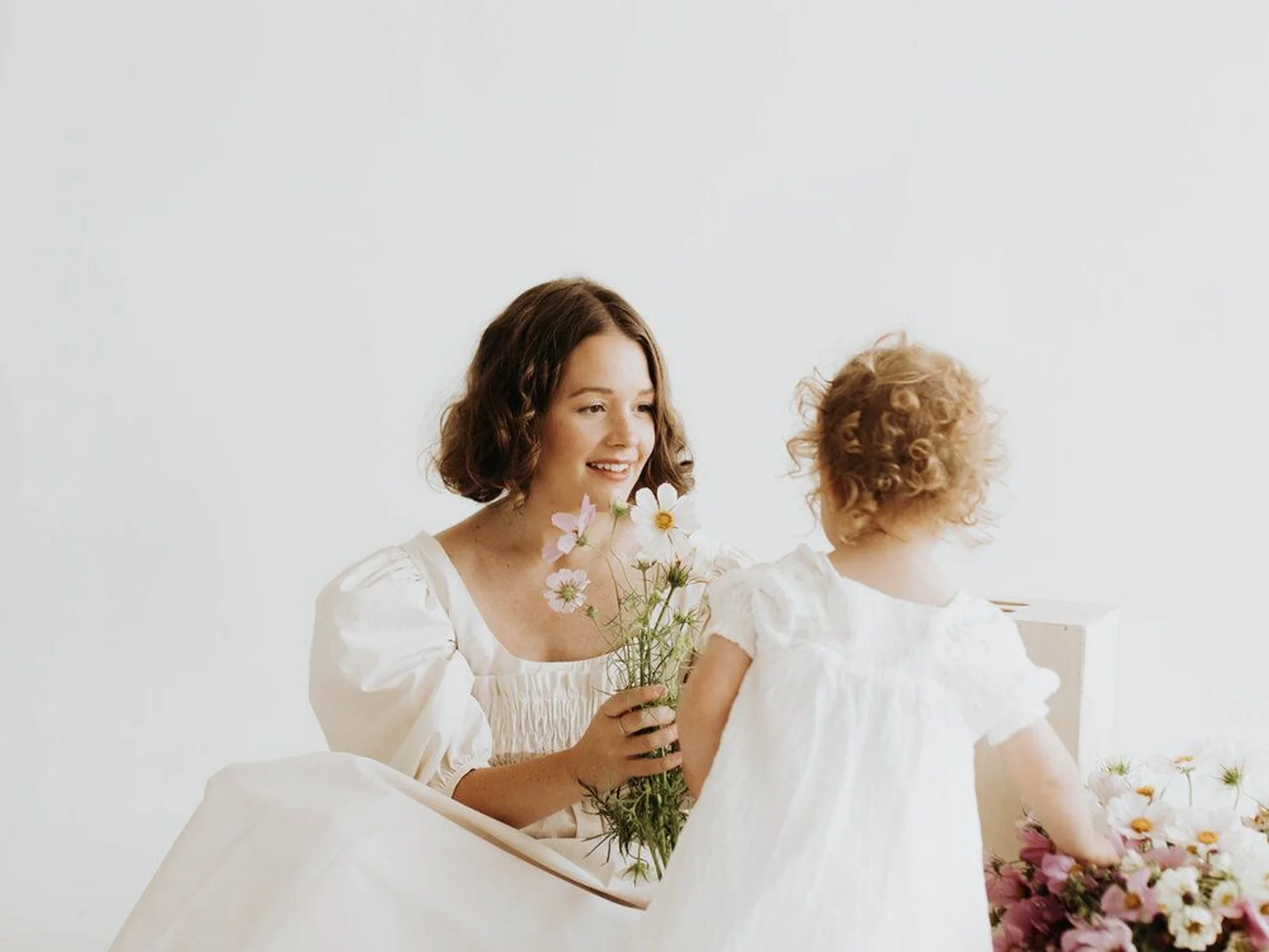 Mother and daughter holding flowers together