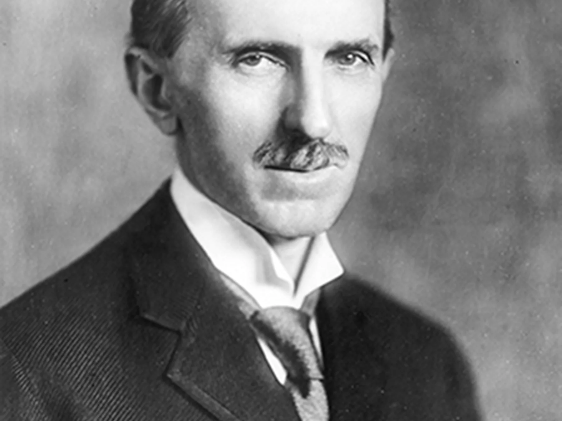 Formal black-and-white portrait of Nikola Tesla