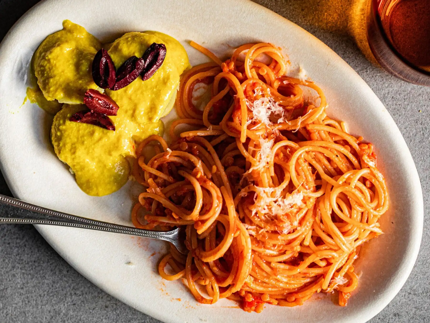 Spaghetti and stuffed pasta on a dinner plate