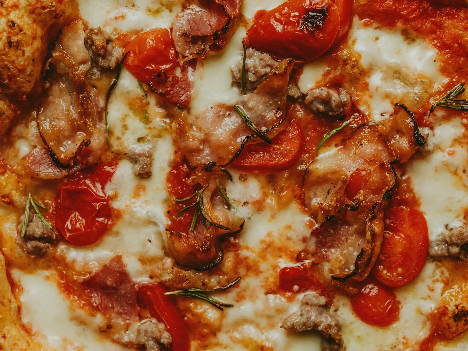 Freshly baked pizza topped with mozzarella, tomatoes, and herbs