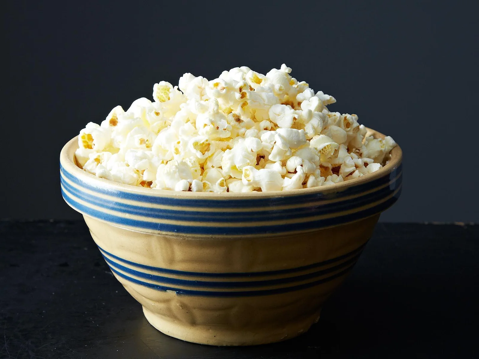 Fresh popcorn in a striped bowl