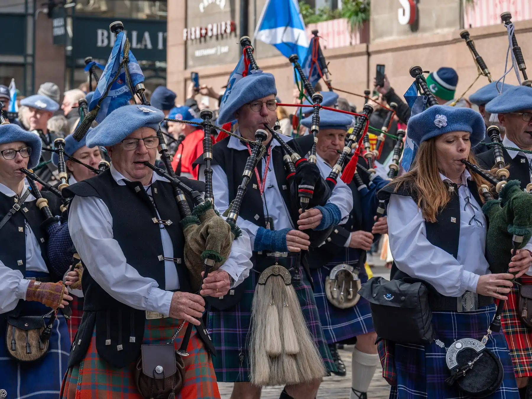 Group of Scottish bagpipers performing in traditional dress
