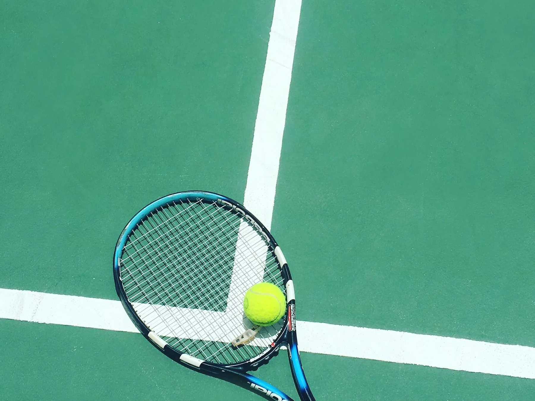 Tennis racket and ball on a court