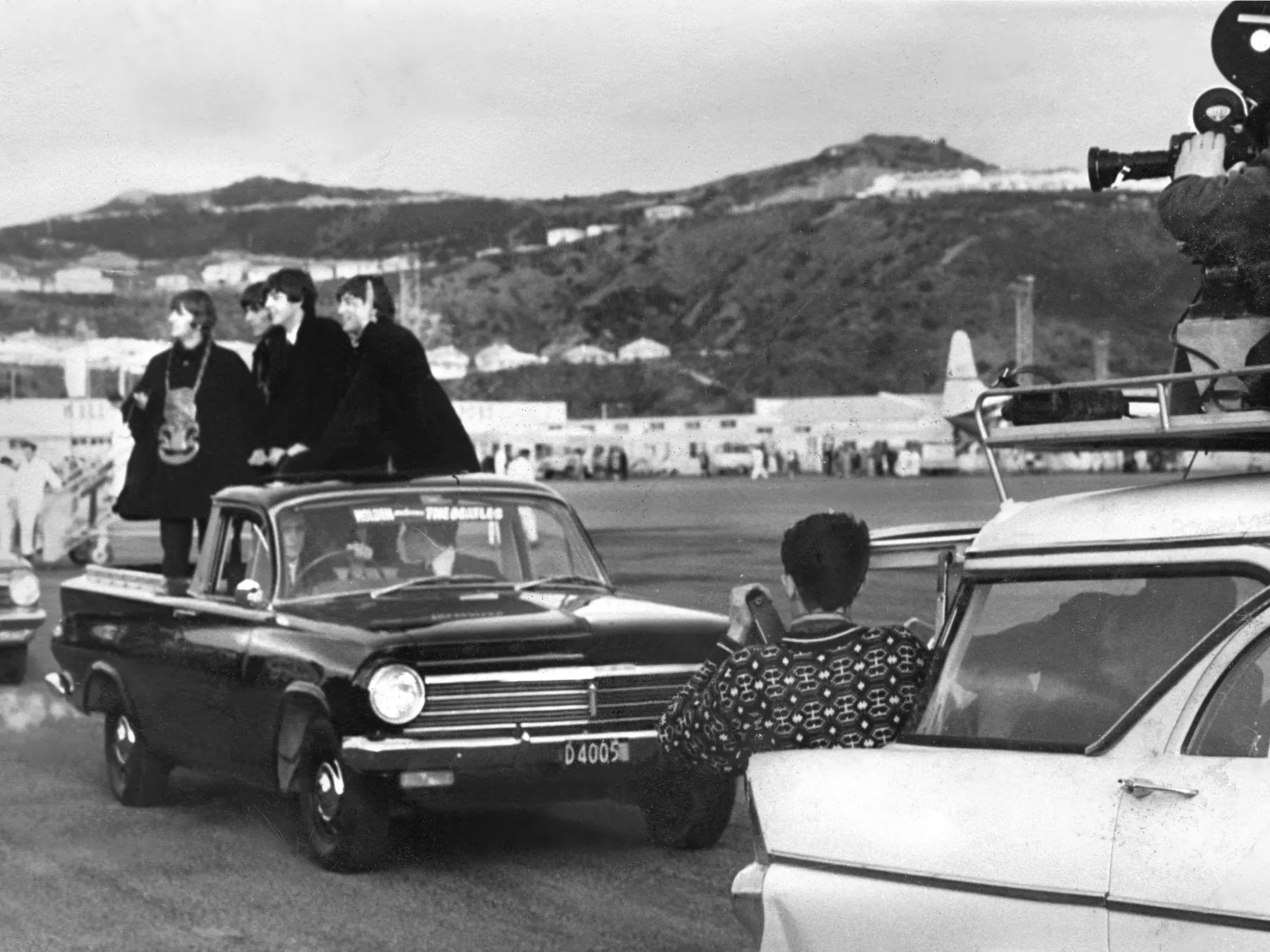The Beatles riding in an open-top car during their 1964 visit to Wellington