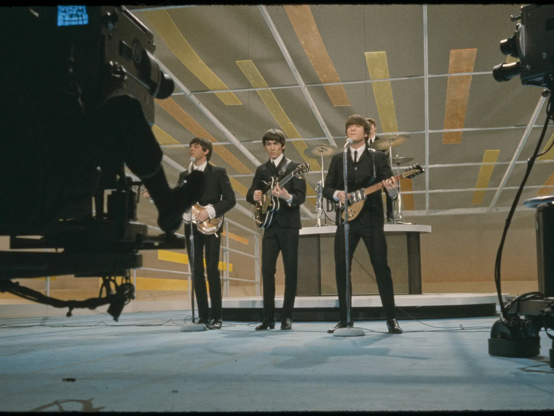 The Beatles performing together onstage in the 1960s