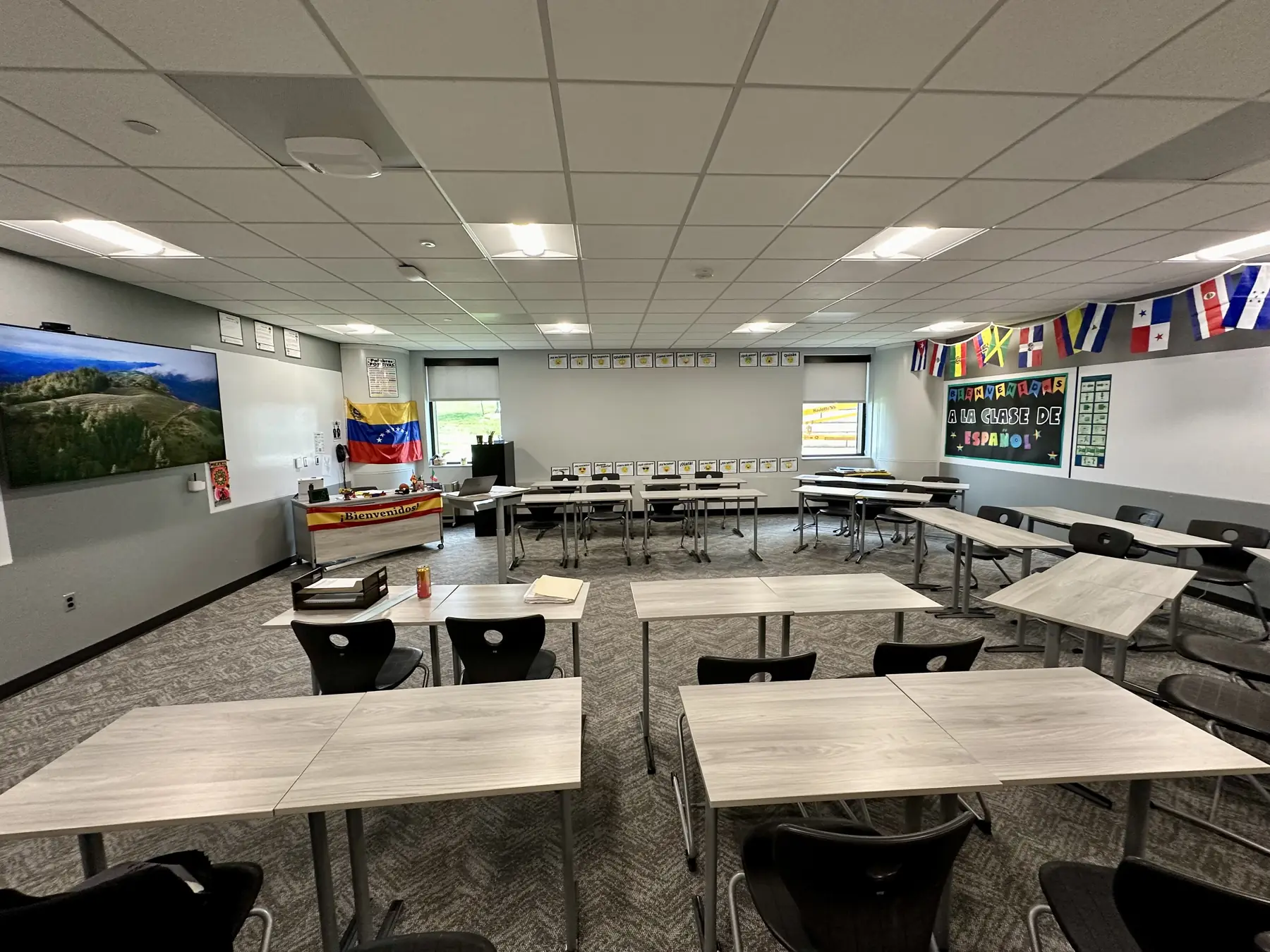 Empty English language classroom with desks and learning displays