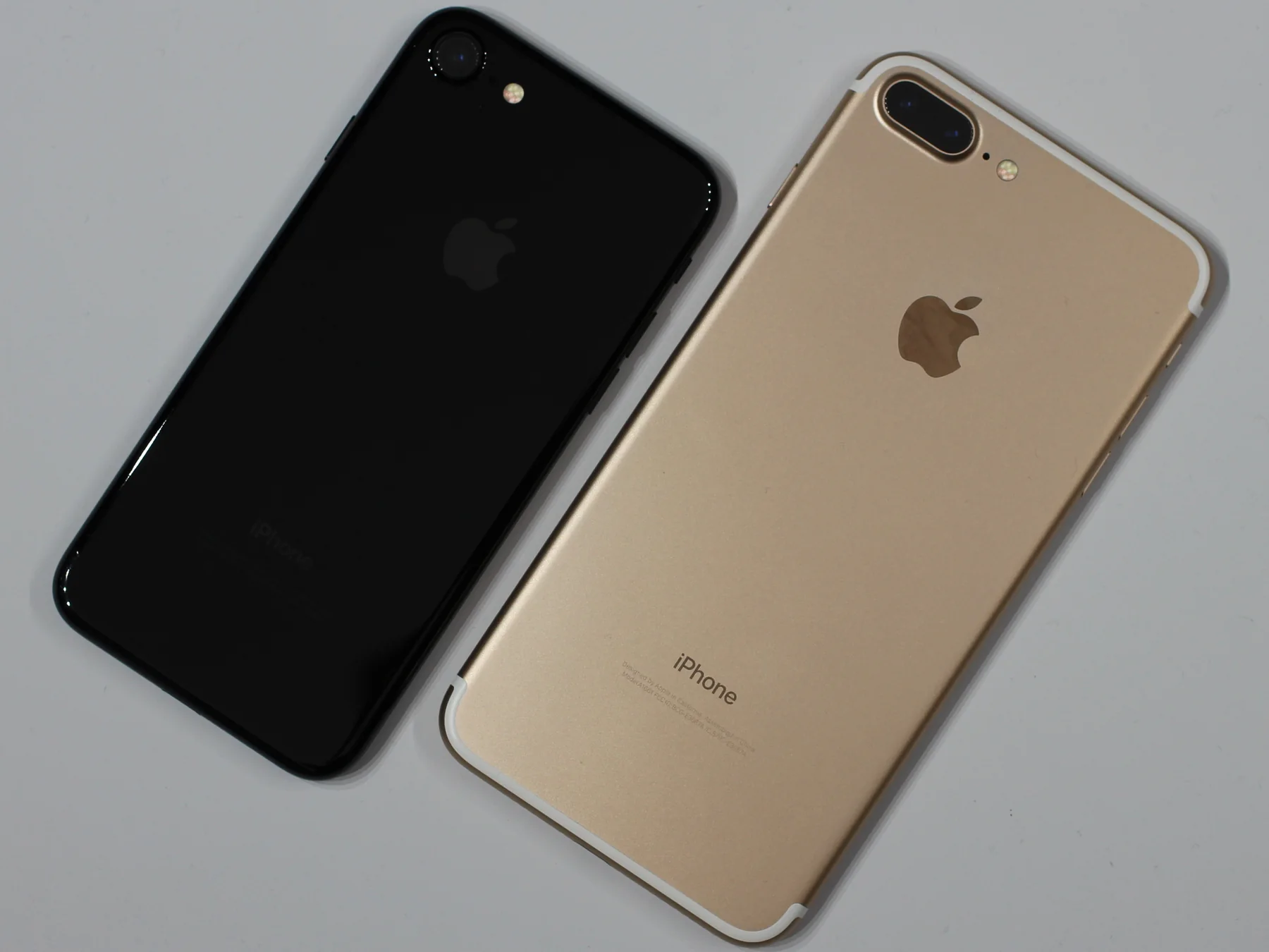 Black and gold Apple iPhone 7 models viewed from the back