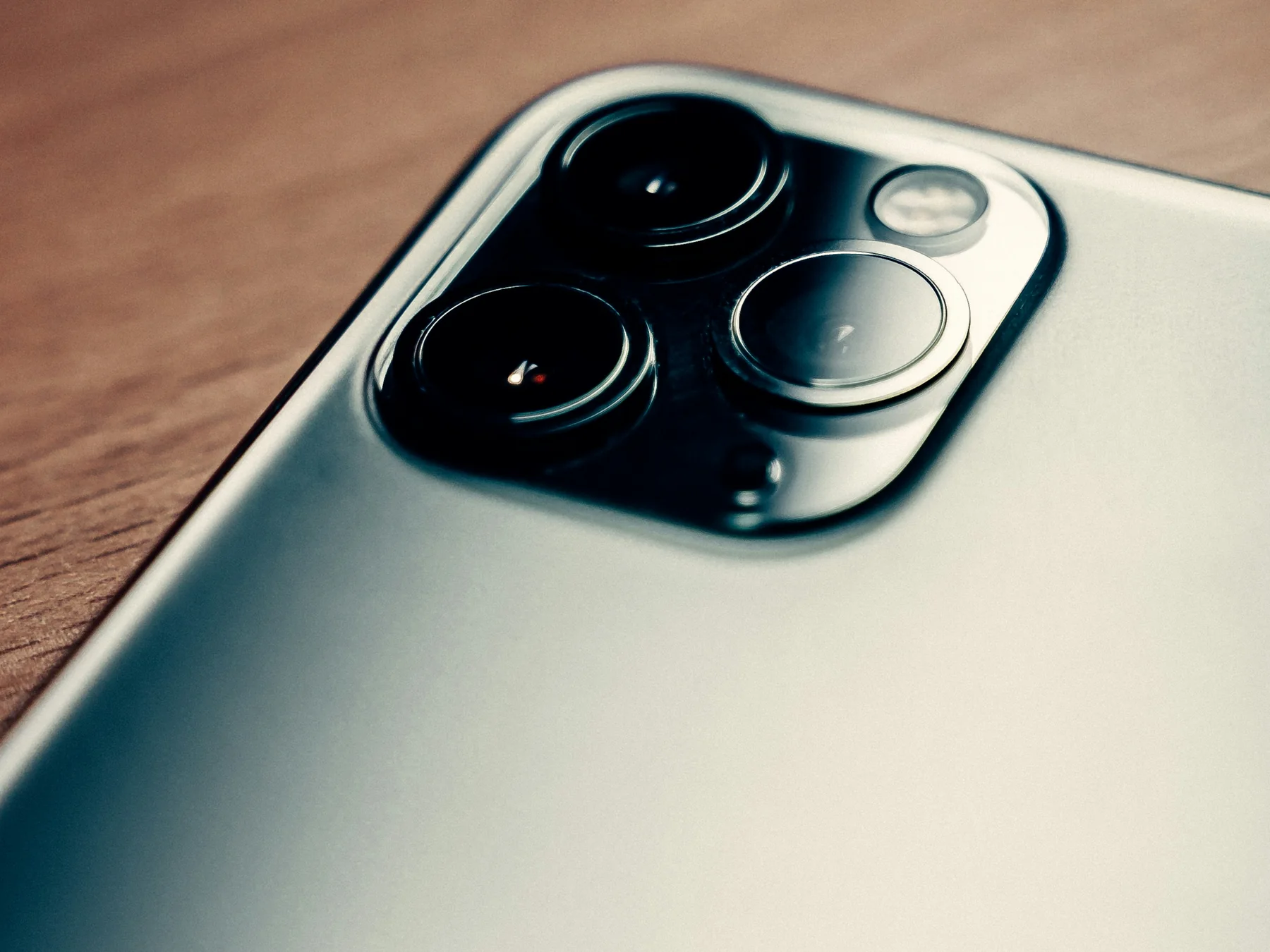Close-up of the triple-lens camera system on an Apple iPhone Pro