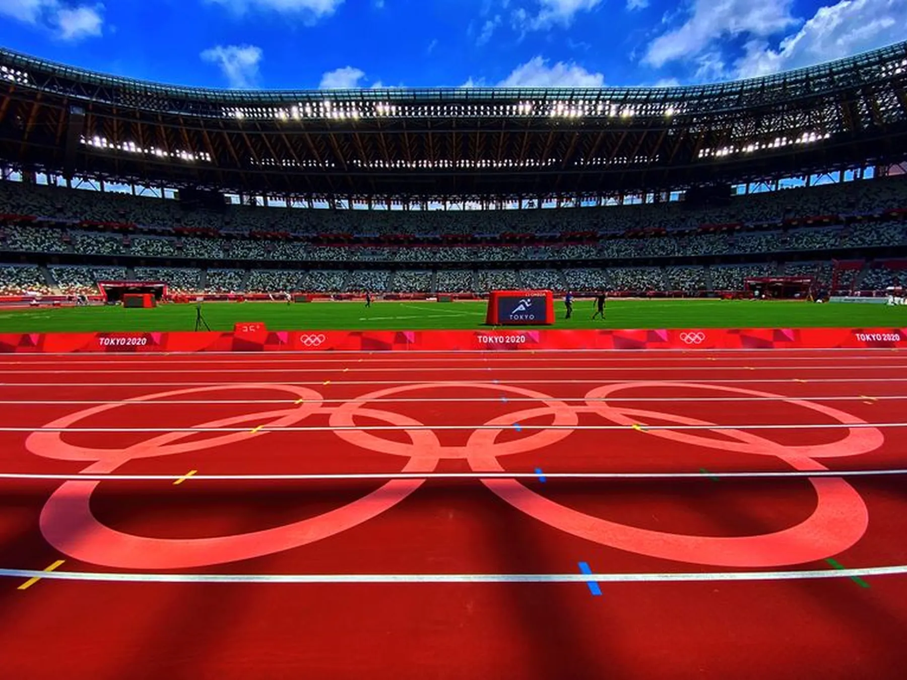 Olympic rings painted across the running track inside a stadium