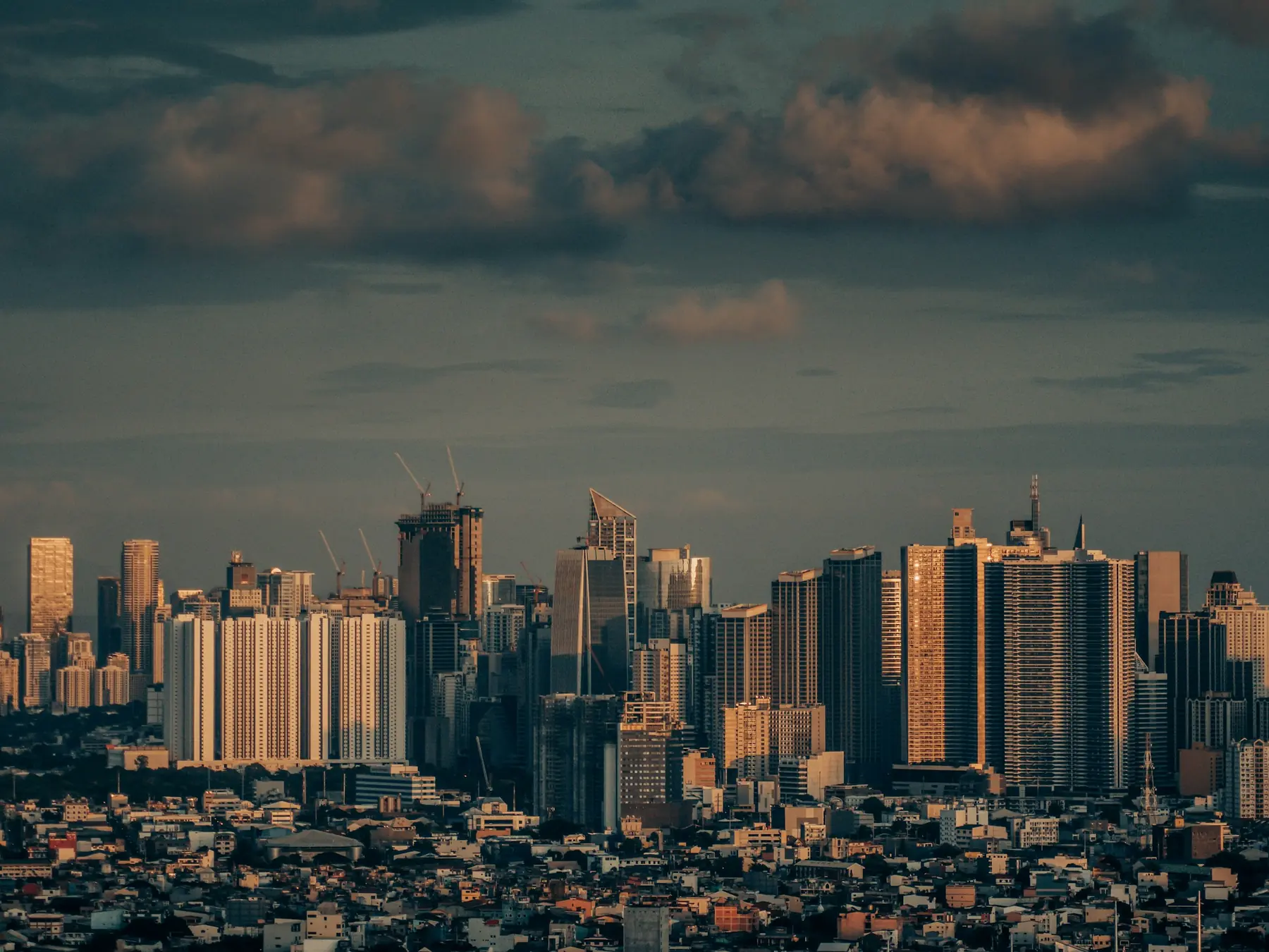 Manila skyline beneath dramatic clouds